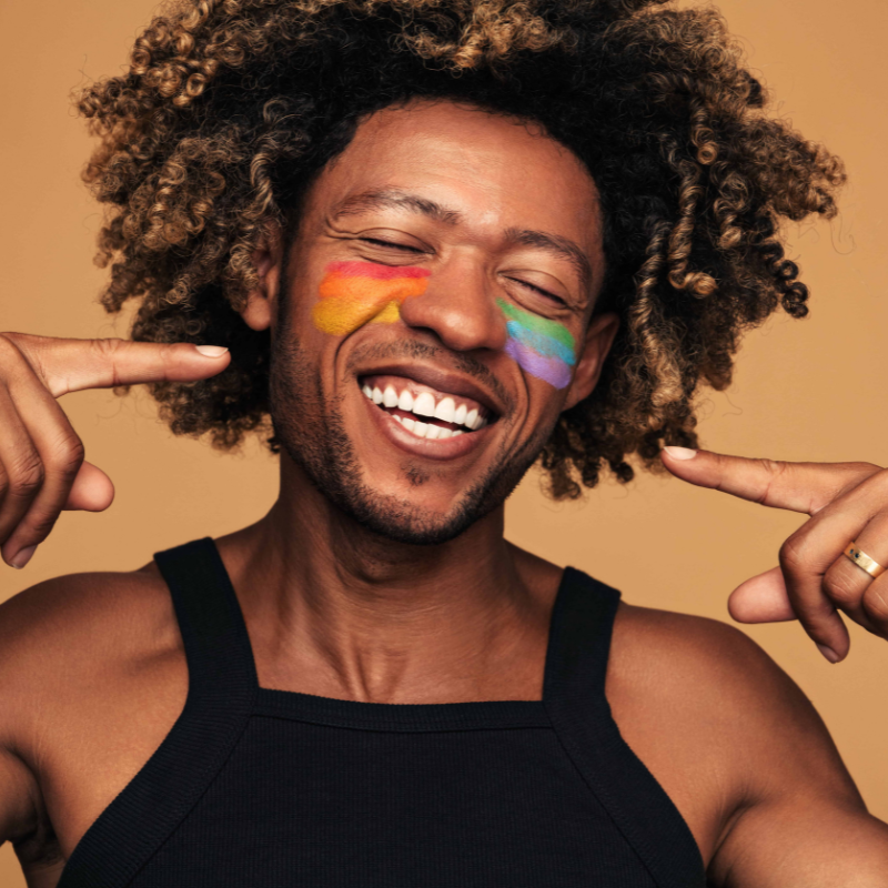 cheerful man pointing at face
